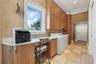 From beach towels to holiday linens, there's a place for everything in this thoughtfully planned utility room where storage and function go hand in ha