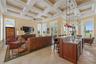Beneath an impressive coffered ceiling, the family room blends comfort and sophistication.