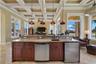 A spacious family room, dedicated wet bar, and dual wine refrigeration create aninviting gathering space.
