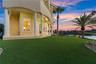 A stretch of emerald lawn meets water, palms, and open sky—creating the perfect backdrop for sunset gatherings, outdoor games, or simply enjoying the 