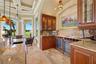 Granite countertops, custom wood cabinetry, dual wine coolers, and a dedicated beverage station create the perfect setting for sharing a favorite vint