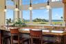 Morning coffee comes with a view in this remarkable kitchen, where sweeping vistas of the golf course stretch toward the sparkling Atlantic Ocean beyo