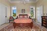Sunlight filters through towering windows, creating a bright and inviting retreat where guests can enjoy both comfort and privacy. Complete with a spa