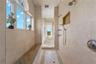 A walk-through shower spacious enough to linger, the shower combines natural stone, handcrafted details, and a calming retreat-like atmosphere.