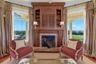 A perfect pairing of artistry and comfort, the custom built-ins and fireplace invite quiet reflection while showcasing the beauty beyond the windows.