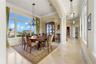 Framed by stately columns and illuminated by oversized windows, the formal dining room offers an elegant setting for intimate dinners and festive cele