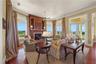 Framed by walls of windows and anchored by a richly crafted fireplace, this room was made for memorable moments shared with family and friends.