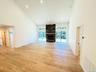 Gorgeous floors, Full glass wall looking outside, stone fireplace
