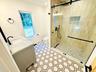 Gorgeous tiled shower and lovely  decorative tile.