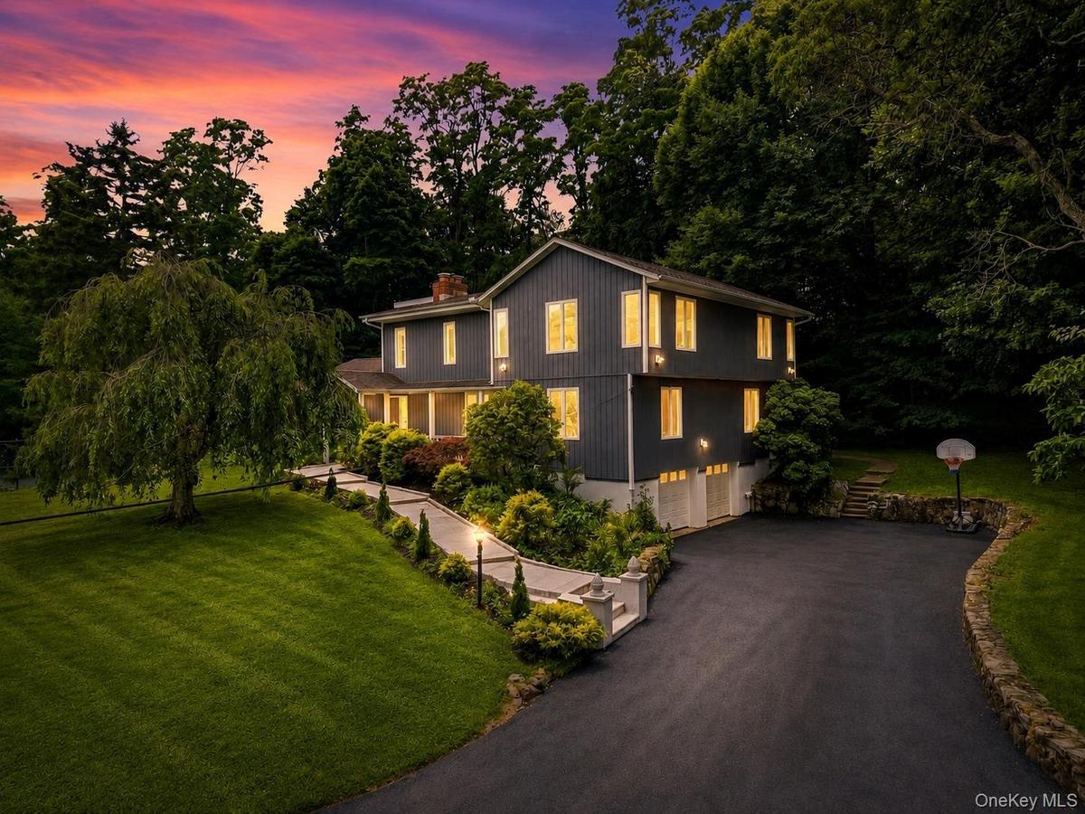 Two-story residence with dark siding and white trim