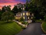 Two-story residence with dark siding and white trim