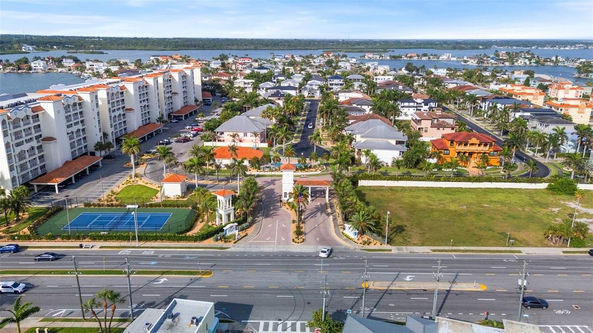 Community over view: from left : •4 condo buildings (waterfront pools , docks , and boardwalks.•tennis courts, parking lot, community clubhouse ( cent
