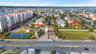 Community over view: from left : •4 condo buildings (waterfront pools , docks , and boardwalks.•tennis courts, parking lot, community clubhouse ( cent