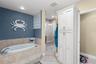 Primary bath garden disking tub to stand in glass enclosed shower with bench