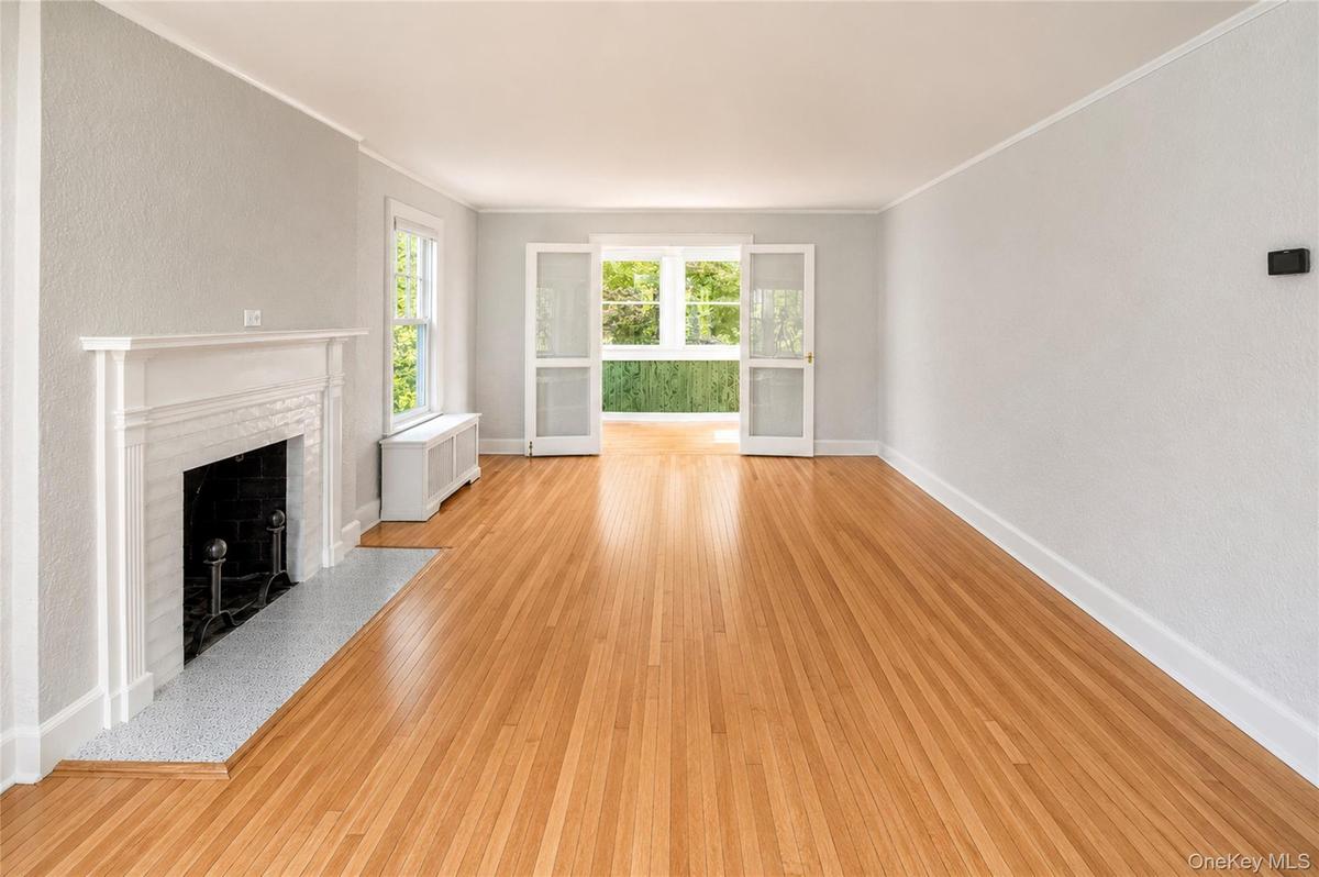 Living room w/ wood burning fire place.