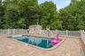 In-ground saltwater/heated swimming pool with an integrated spa, surrounded by paver decking