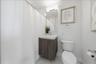 Well-appointed secondary bathroom with stone finishes.