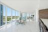 Floor-to-ceiling impact glass filling the home with natural light.