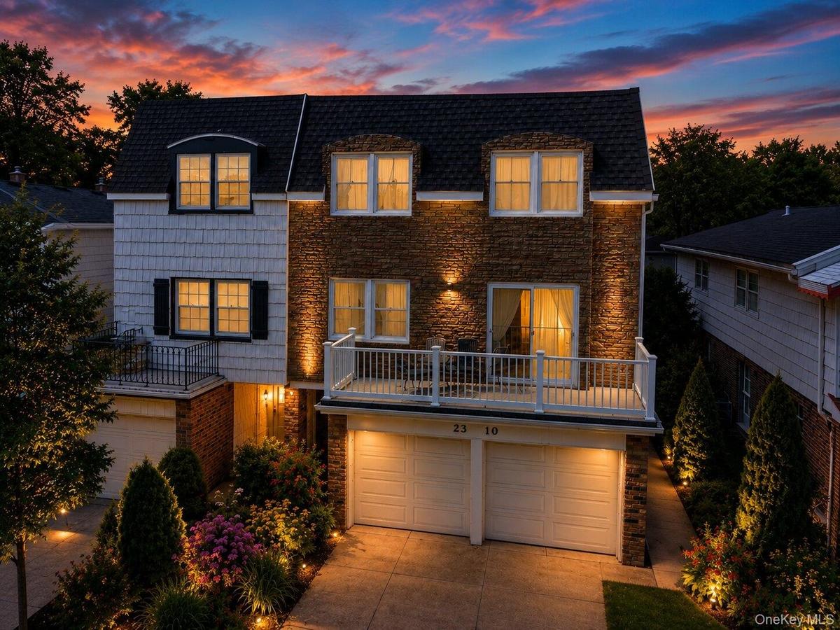 Stone and shingle-sided exterior with integrated two-car garage