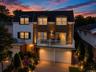 Stone and shingle-sided exterior with integrated two-car garage