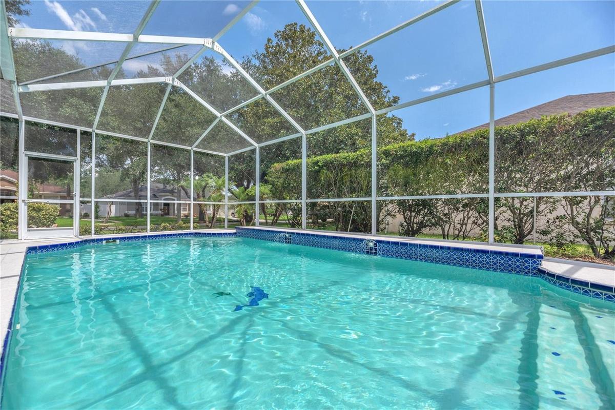 Large pool with two elegant water fountains cascading from the back wall.
