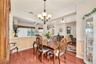 A large architectural opening between the dining room and family room enhances the home's open feel while maintaining distinct gathering spaces.