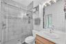 Bathroom #3 with a spacious walk-in shower and exterior access to the pool making entertaining easy while helping keep the main living areas clean and