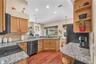 Chef-inspired kitchen Featuring black stainless steel appliances, abundant cabinetry, generous granite counter space, breakfast bar seating