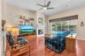The expansive family room showcases beautiful flooring, wood burning fireplace and triple sliding glass doors that fully open to your own private back