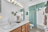 well-appointed guest bath with dual vanities and a tub/shower combination.