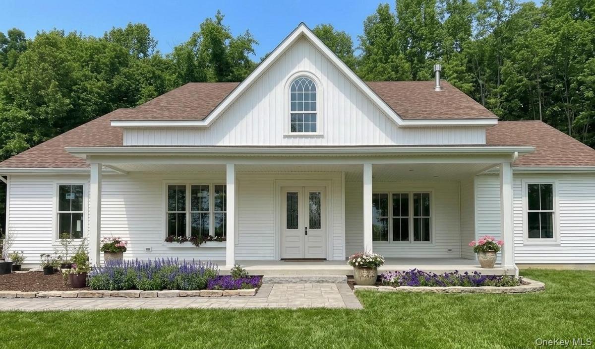 Virtually staged to show a possible stone walkway and stone flower beds