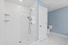 Previously built depicts linen closet, tiled floors and large walk in shower with glass enclosure. All subject to change