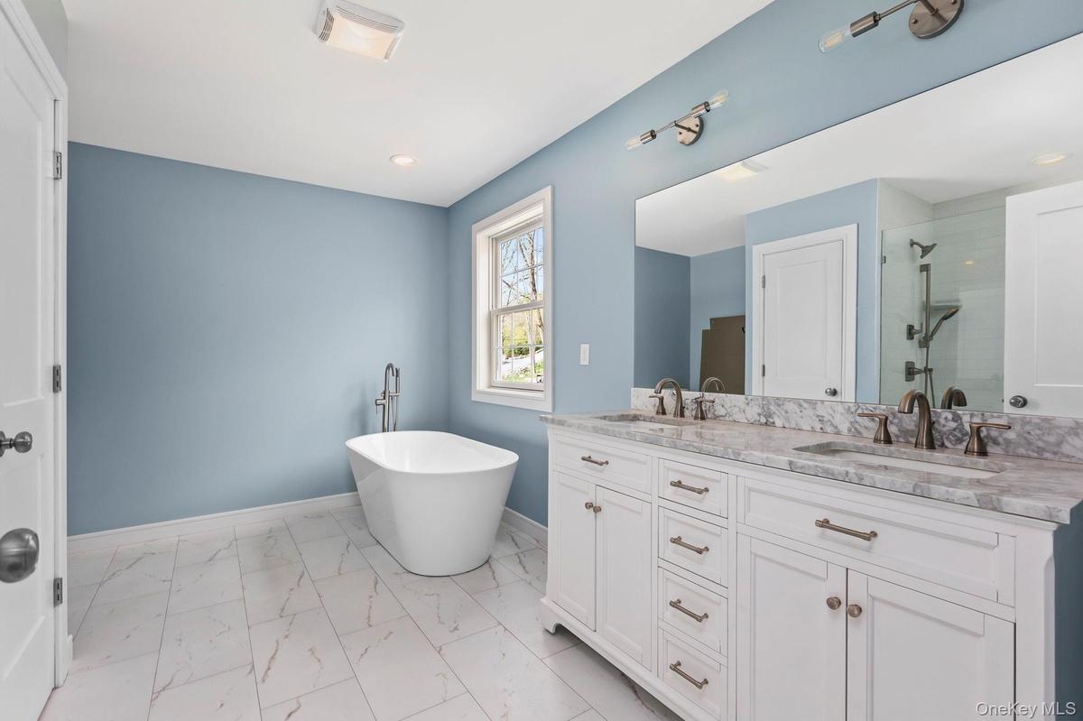 Features of previous built show dual vanity and stand alone soaking tub.All subject to change