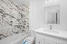 Depicting one of the hall baths with tiled shower/tub combo and vanity that was featured in another home built by the same buildersAll subject to chan