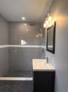 Full bathroom with tiled shower and vanity