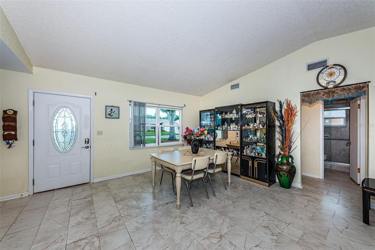 Living and dining room with access to the guest bathroom and 2 bedrooms.