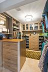 Primary WIC w/ custom bulitouts for maximum storage & glass face upper cabinets