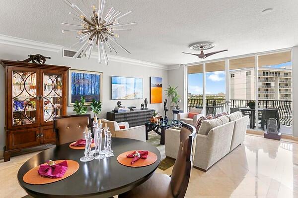 Living/Dining RM w/ designer light fixtures & marble floor through-out home