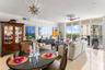 Living/Dining RM w/ designer light fixtures & marble floor through-out home
