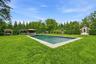 Rectangular inground salt water pool with stone coping, entertaining cabana in the back-ground