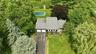 Ranch-style residence featuring a prominent two-car garage, asphalt driveway, and a shingle roof