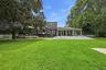 Spacious backyard featuring a substantial lawn and mature trees