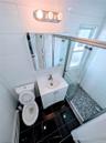 Full bathroom featuring toilet, a shower stall, and vanity