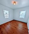 Spare room with baseboard heating, baseboards, and wood finished floors