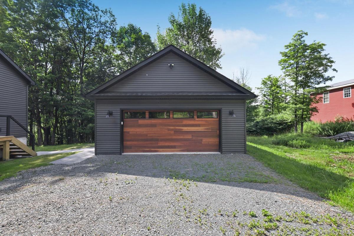 Two car garage from with walkway to the home.