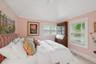 Bedroom with vaulted ceiling and baseboards