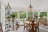 Sunroom with lofted ceiling, plenty of natural light, stone tile flooring, and wooden ceiling