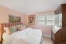 Carpeted bedroom featuring lofted ceiling and baseboards