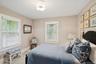 Bedroom with carpet floors and wallpapered walls