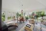 Sunroom / solarium featuring french doors, high vaulted ceiling, and stone finish floors